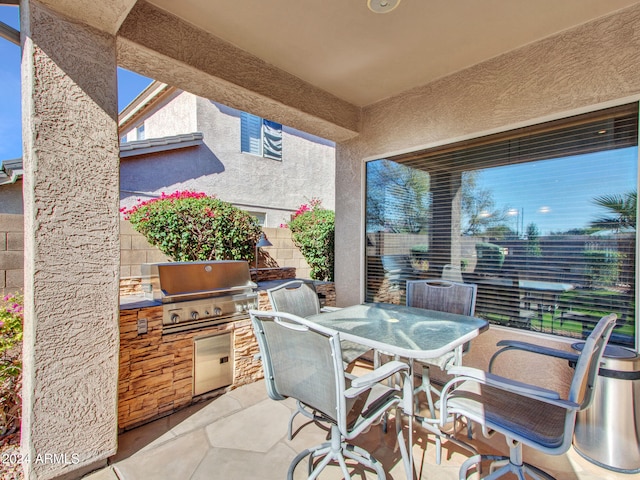 view of patio / terrace with exterior kitchen and a grill