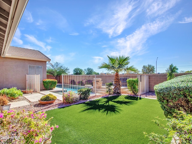 view of yard with a patio area and a fenced in pool