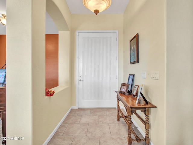 doorway to outside featuring light tile patterned floors