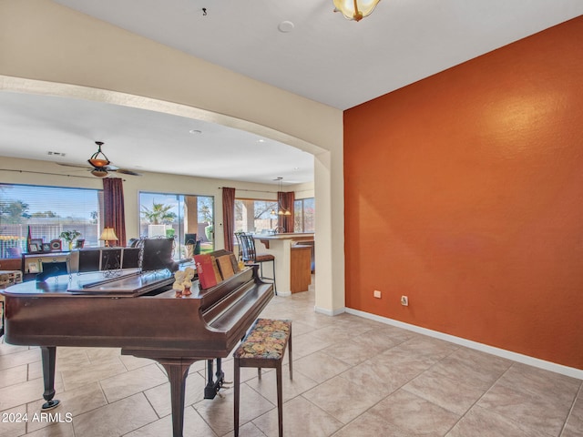 misc room featuring light tile patterned flooring and ceiling fan