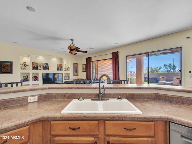 kitchen featuring dishwasher, sink, built in features, and ceiling fan