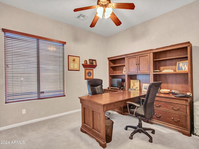 carpeted office featuring ceiling fan