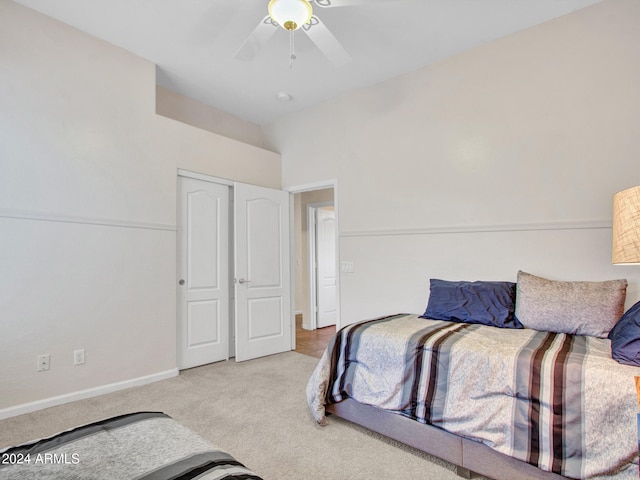 carpeted bedroom featuring a closet and ceiling fan