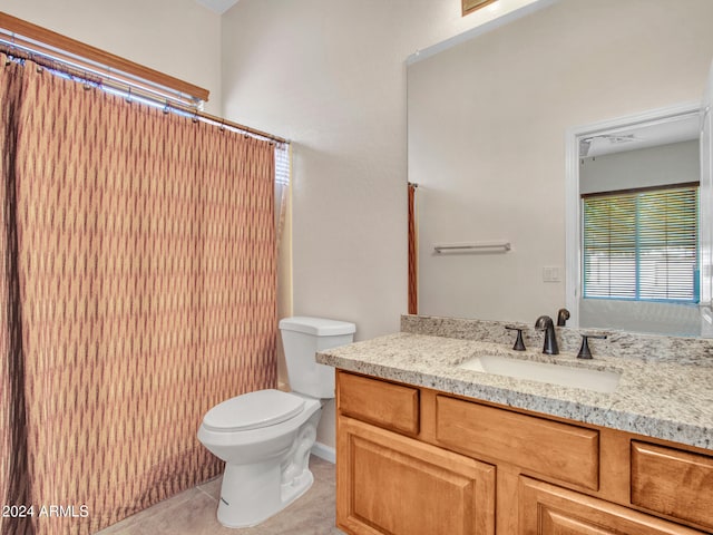 bathroom with vanity, toilet, and tile patterned flooring