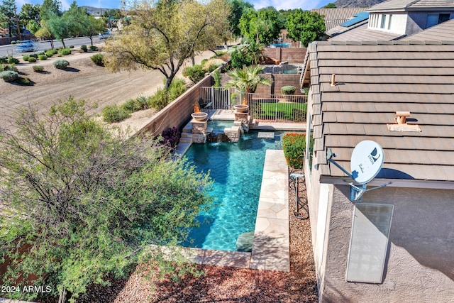 view of pool featuring pool water feature and a patio