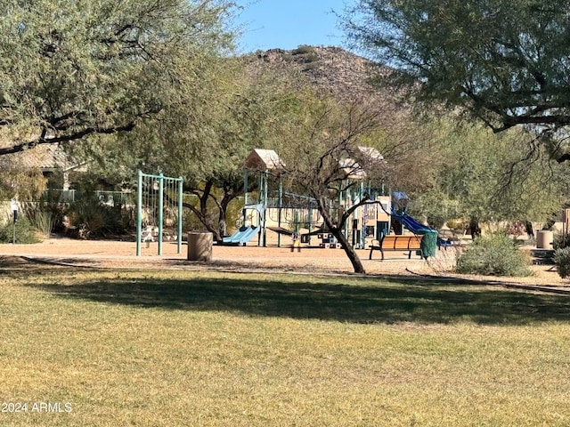 view of play area featuring a mountain view and a lawn