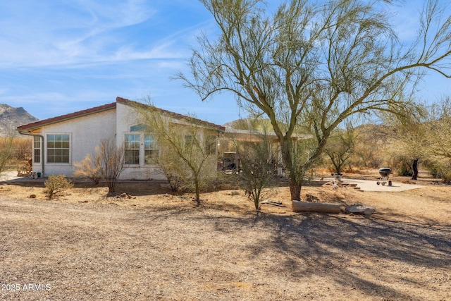 view of side of property featuring stucco siding