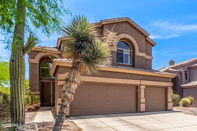 3055 N Red Mtn Unit 98, Mesa, AZ 85207 - mediterranean / spanish-style home featuring concrete driveway, stucco siding, and an attached garage