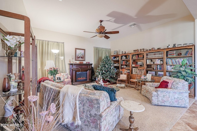 carpeted living room with a fireplace and ceiling fan