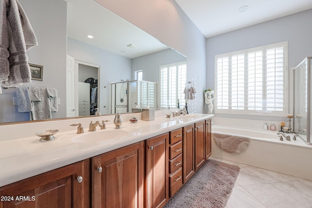 bathroom with vanity, a healthy amount of sunlight, and shower with separate bathtub