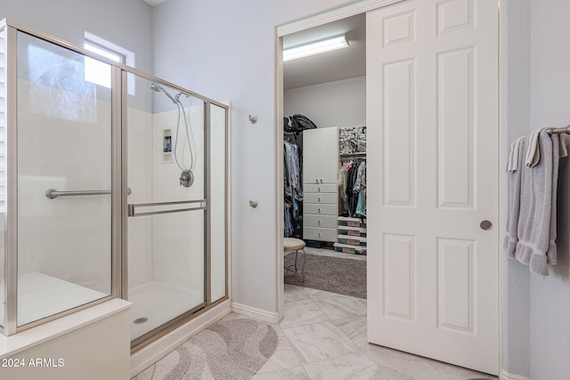 bathroom featuring a shower with shower door