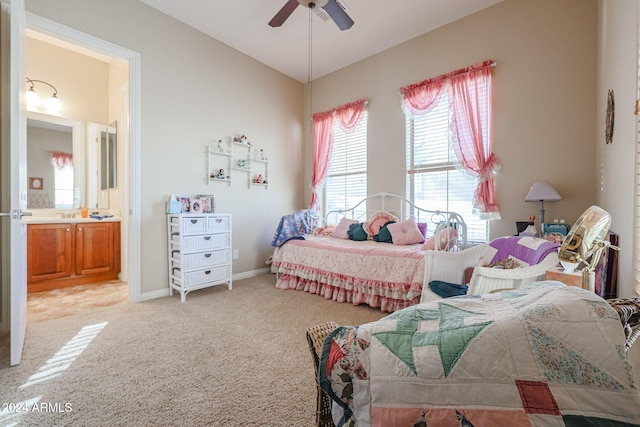 carpeted bedroom featuring connected bathroom and ceiling fan