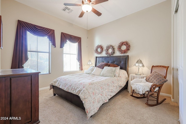 bedroom with ceiling fan and light colored carpet