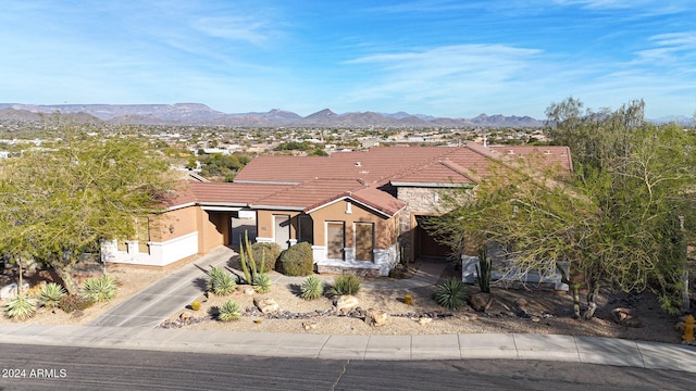 view of front facade with a mountain view and a garage