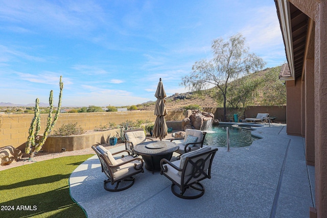 view of patio with a fenced in pool and pool water feature