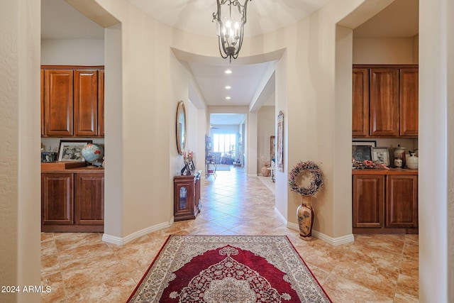 hallway with a chandelier