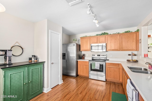 kitchen featuring sink, stainless steel appliances, and light hardwood / wood-style floors