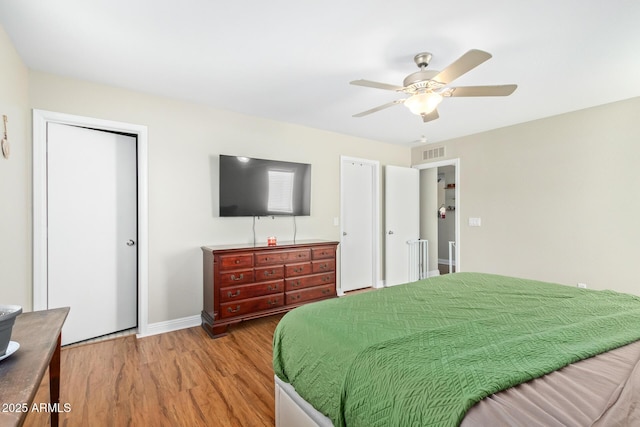 bedroom with ceiling fan and wood-type flooring