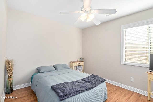 bedroom with ceiling fan and light wood-type flooring