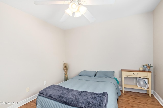 bedroom with hardwood / wood-style floors and ceiling fan