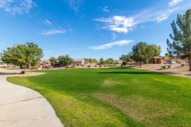 surrounding community with a playground and a yard