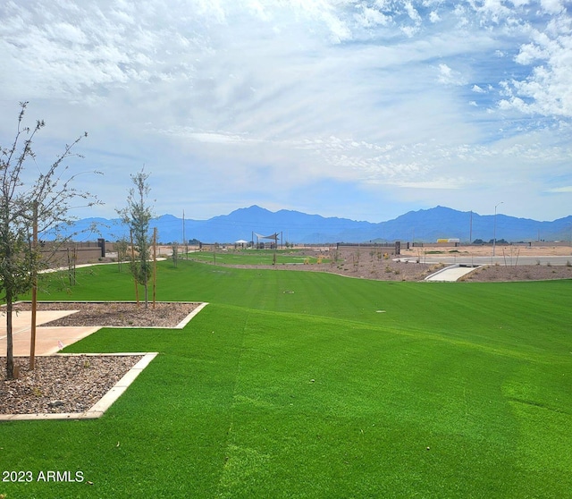 view of home's community featuring a mountain view and a lawn