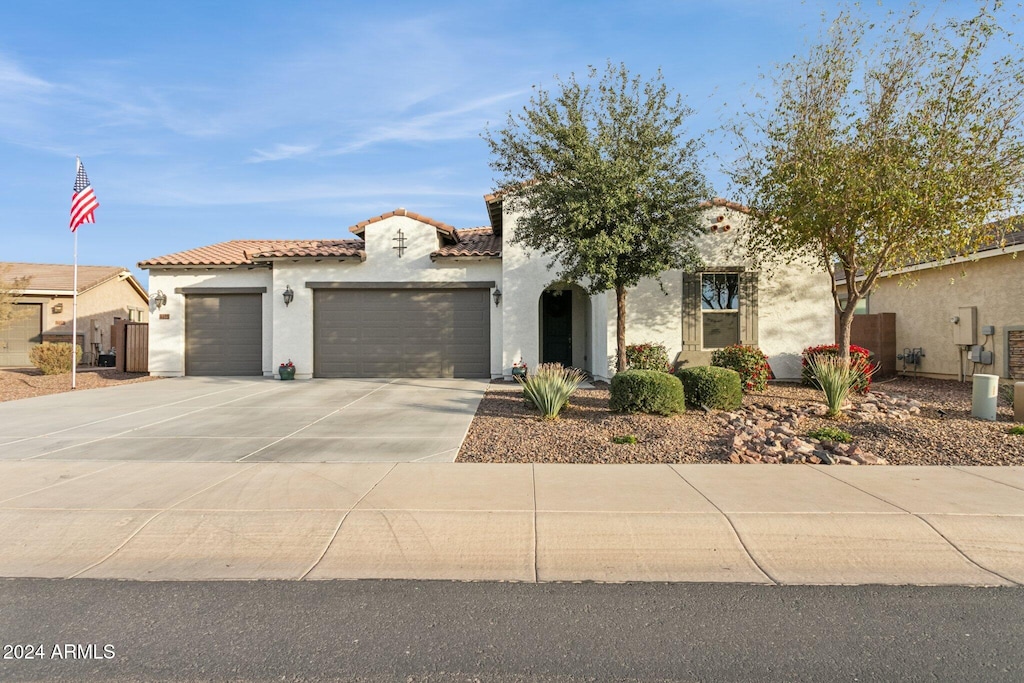 mediterranean / spanish-style home featuring a garage