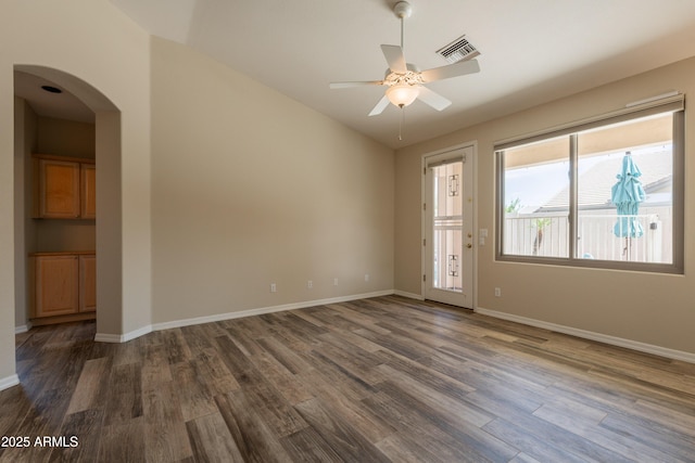 1555 E Monterey St, Chandler, AZ 85225 - unfurnished room featuring ceiling fan, dark wood-style flooring, arched walkways, baseboards, and lofted ceiling