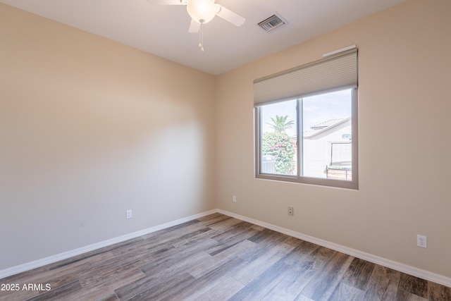 1555 E Monterey St, Chandler, AZ 85225 - unfurnished room with wood finished floors, baseboards, and a ceiling fan