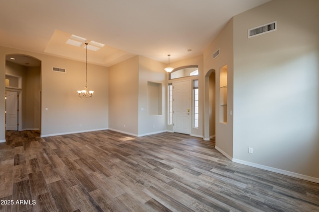 1555 E Monterey St, Chandler, AZ 85225 - foyer with arched walkways, wood finished floors, baseboards, and a chandelier