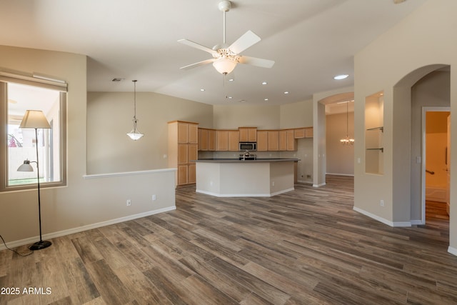 1555 E Monterey St, Chandler, AZ 85225 - kitchen with stainless steel microwave, open floor plan, light brown cabinets, dark countertops, and arched walkways