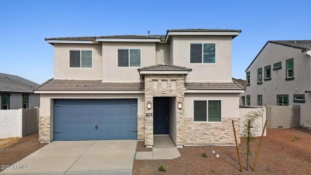 view of front of property featuring a garage and a mountain view