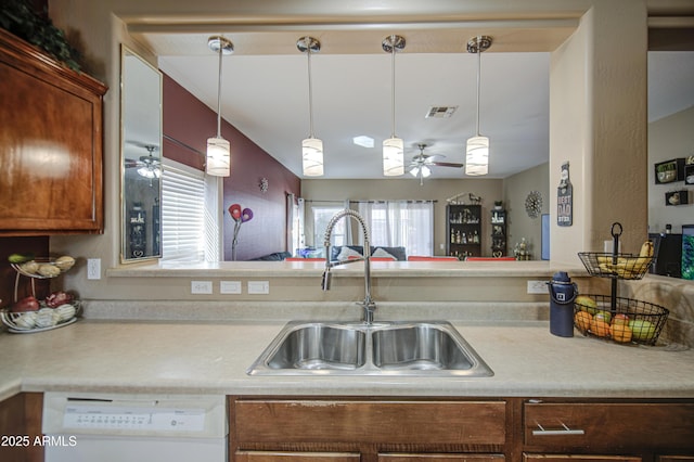 kitchen featuring a ceiling fan, visible vents, white dishwasher, light countertops, and a sink