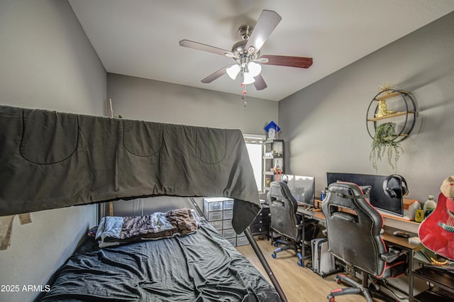 bedroom featuring a ceiling fan and wood finished floors