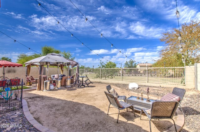 exterior space featuring a gazebo, a fenced backyard, and a patio