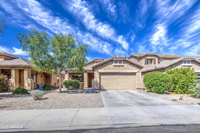 view of front of home with a garage, stucco siding, a tile roof, and concrete driveway