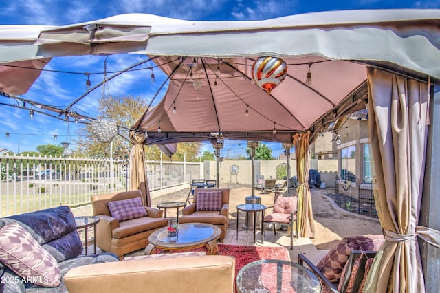 view of patio / terrace featuring a fenced backyard, outdoor dining space, a gazebo, and outdoor lounge area