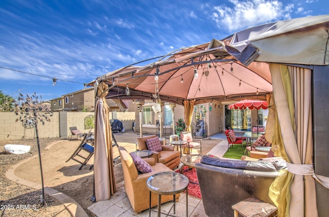 view of patio with a gazebo, a fenced backyard, and an outdoor living space