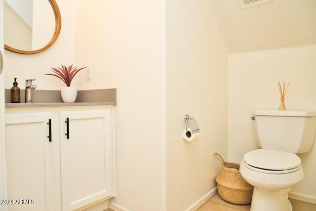 bathroom featuring tile patterned floors, vanity, and toilet