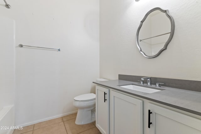 bathroom with toilet, vanity, and tile patterned floors