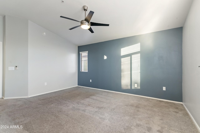 carpeted empty room featuring ceiling fan and plenty of natural light