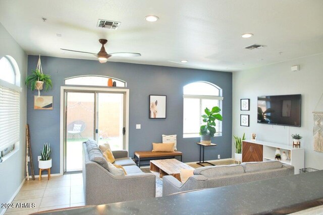 tiled living room with ceiling fan