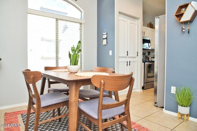 dining space featuring light tile patterned floors