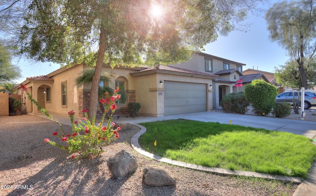 44977 W Miraflores St, Maricopa, AZ 85139 - view of front of house with stucco siding, concrete driveway, a garage, a tiled roof, and a front yard