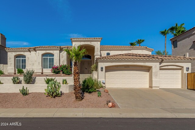 mediterranean / spanish-style home with a garage