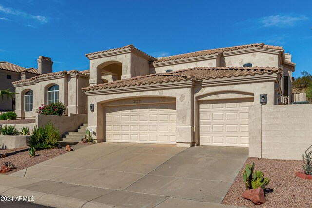 mediterranean / spanish house featuring a mountain view and a garage