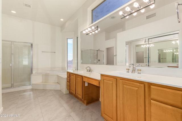 bathroom featuring a garden tub, double vanity, visible vents, a stall shower, and a sink