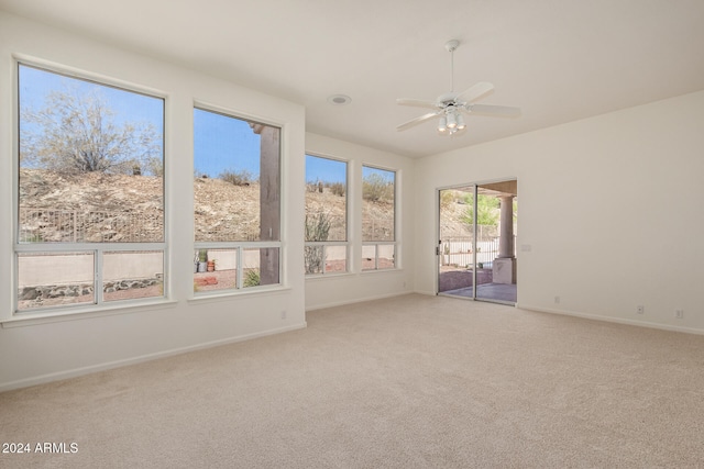 empty room featuring light colored carpet and ceiling fan