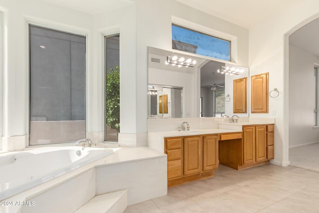 bathroom featuring tile patterned flooring, a garden tub, a sink, and double vanity