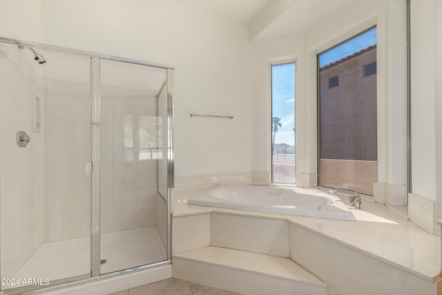 bathroom with separate shower and tub, tile patterned floors, and a healthy amount of sunlight